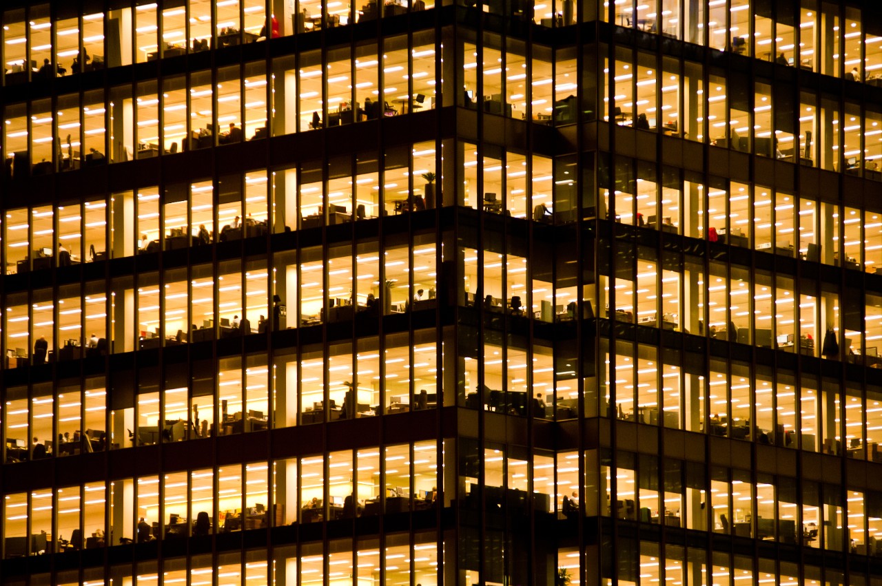 People work in an office building. Full-time employees in the UK work longer hours than the EU average, according to the Office for National Statistics.